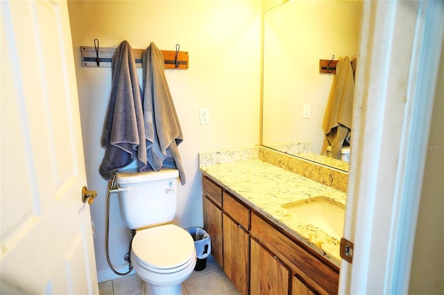 bathroom featuring tile patterned flooring, vanity, and toilet