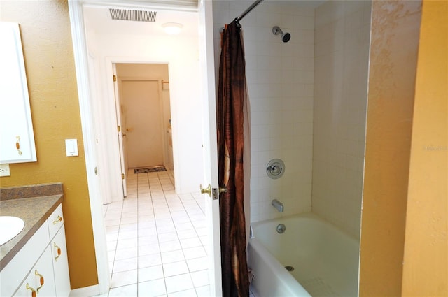 bathroom featuring vanity, tile patterned floors, and shower / bath combo with shower curtain