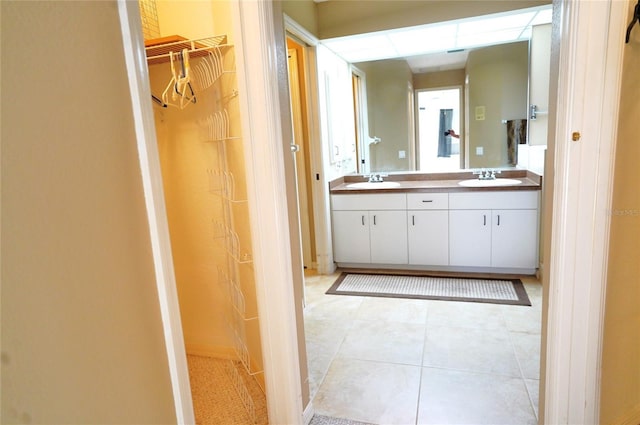 bathroom with tile patterned floors and vanity