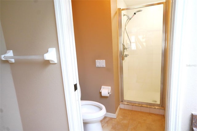 bathroom with a shower with door, tile patterned flooring, and toilet