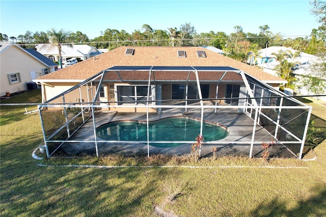 rear view of property featuring a patio, central air condition unit, glass enclosure, and a lawn