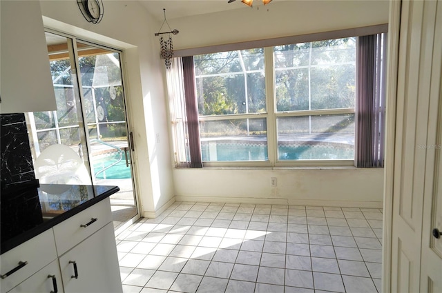 unfurnished dining area with plenty of natural light and light tile patterned flooring