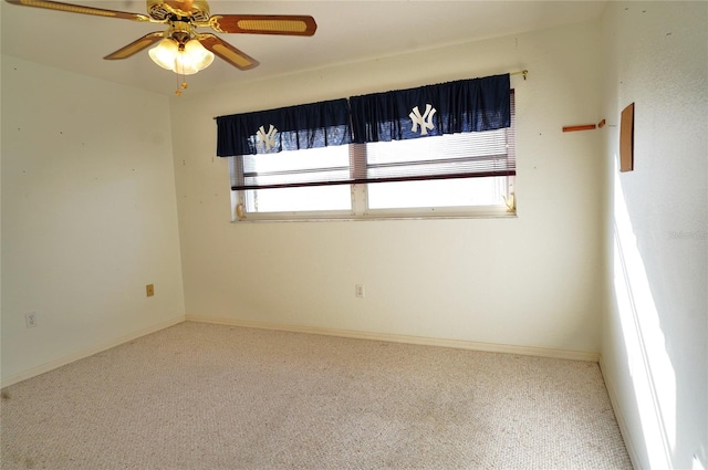 unfurnished room with ceiling fan and carpet flooring