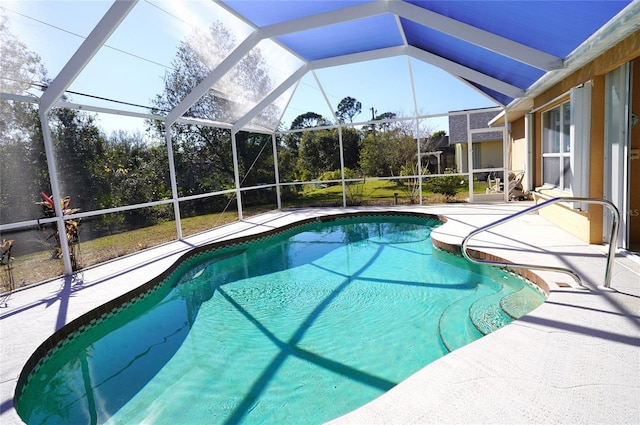 view of swimming pool featuring a patio and a lanai