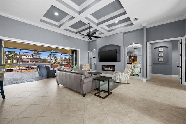 living room with a high ceiling, light tile patterned floors, ornamental molding, and coffered ceiling