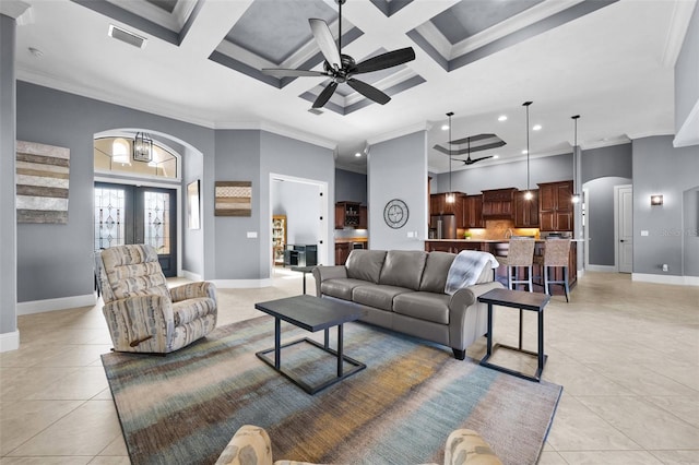 tiled living room with beam ceiling, coffered ceiling, and ornamental molding