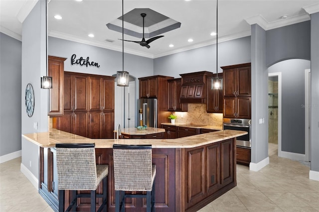 kitchen featuring decorative backsplash, appliances with stainless steel finishes, kitchen peninsula, crown molding, and hanging light fixtures