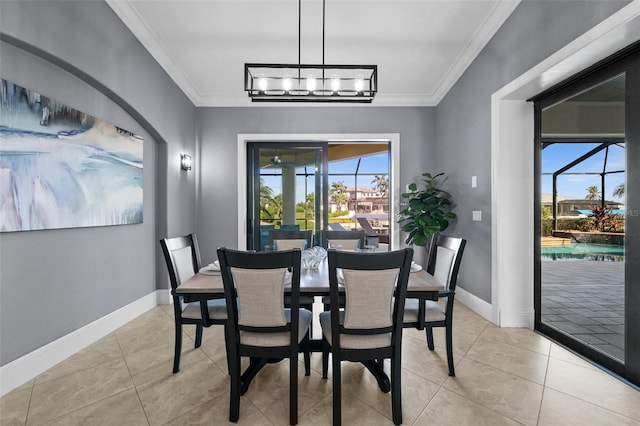 tiled dining area featuring ornamental molding and a notable chandelier