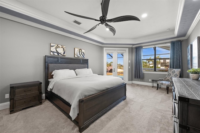 carpeted bedroom with ornamental molding, access to outside, ceiling fan, and a tray ceiling