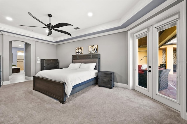 carpeted bedroom with access to outside, ensuite bathroom, a raised ceiling, crown molding, and ceiling fan