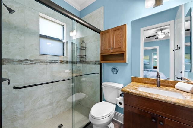 bathroom with ornamental molding, vanity, a shower with door, ceiling fan, and toilet