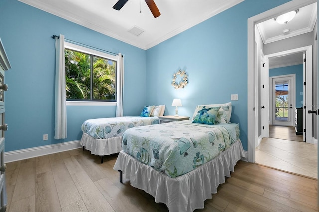 bedroom featuring ceiling fan, wood-type flooring, and ornamental molding