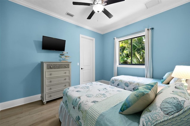 bedroom with ceiling fan, light wood-type flooring, and crown molding