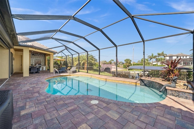 view of swimming pool featuring pool water feature, glass enclosure, and a patio area