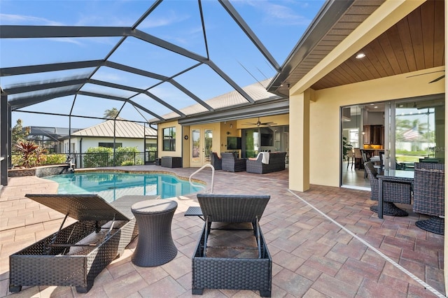 view of swimming pool featuring outdoor lounge area, a patio, ceiling fan, and a lanai