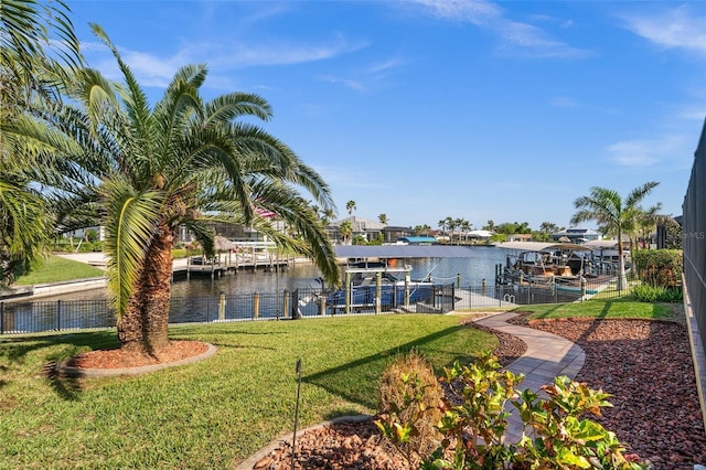 view of dock featuring a water view and a yard