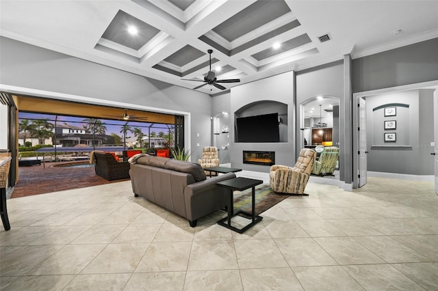 living room with a towering ceiling, crown molding, coffered ceiling, and light tile patterned flooring