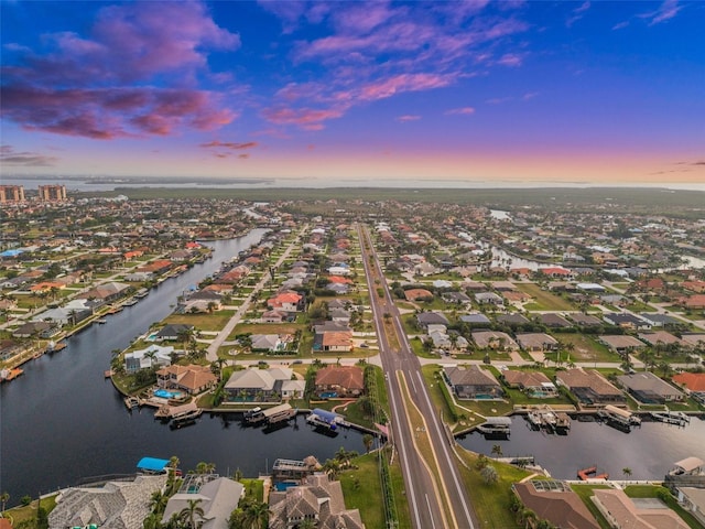 aerial view at dusk with a water view