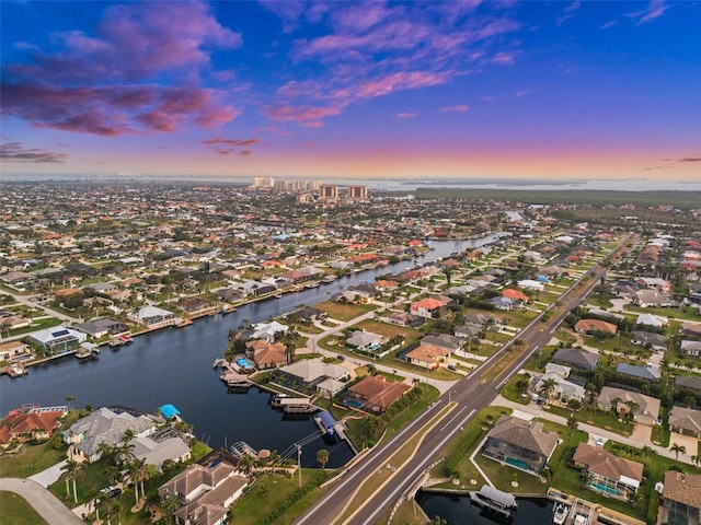 aerial view at dusk with a water view