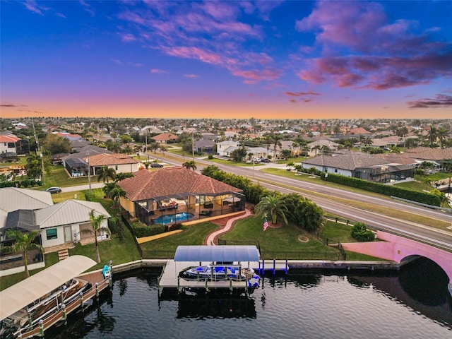 aerial view at dusk with a water view