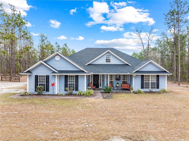 view of front of property with covered porch and a front lawn