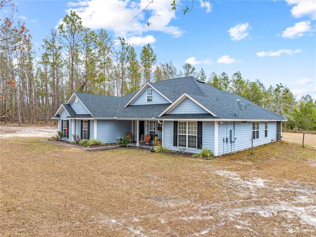 view of front of property with covered porch and a front lawn