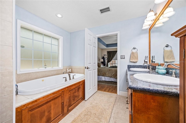 bathroom featuring vanity and a tub