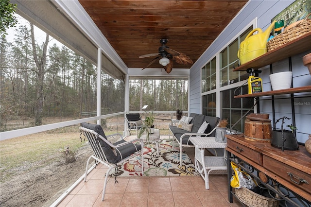 sunroom featuring wood ceiling and ceiling fan