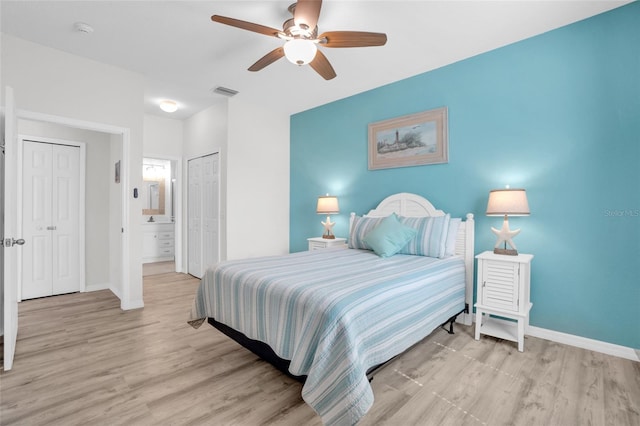 bedroom featuring ensuite bathroom, ceiling fan, and light hardwood / wood-style flooring