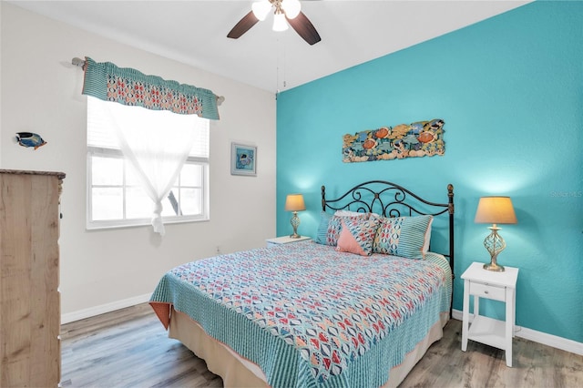 bedroom featuring wood-type flooring and ceiling fan