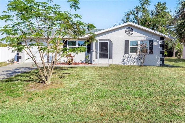 ranch-style home featuring a garage and a front yard