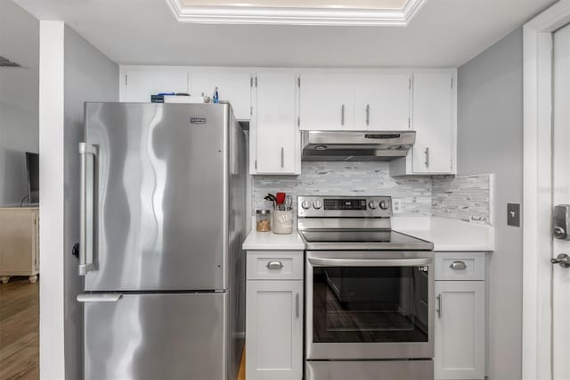 kitchen featuring appliances with stainless steel finishes, white cabinets, and backsplash