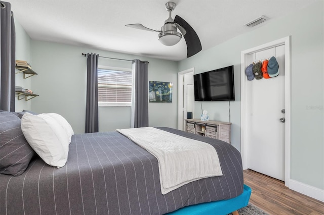 bedroom featuring dark hardwood / wood-style flooring and ceiling fan