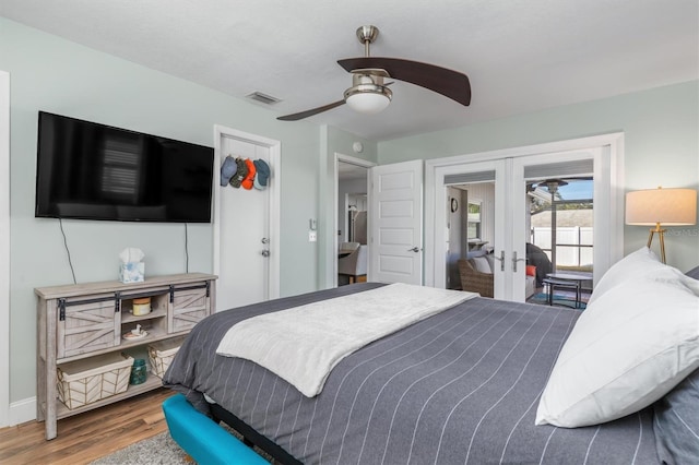 bedroom featuring access to outside, ceiling fan, french doors, and wood-type flooring