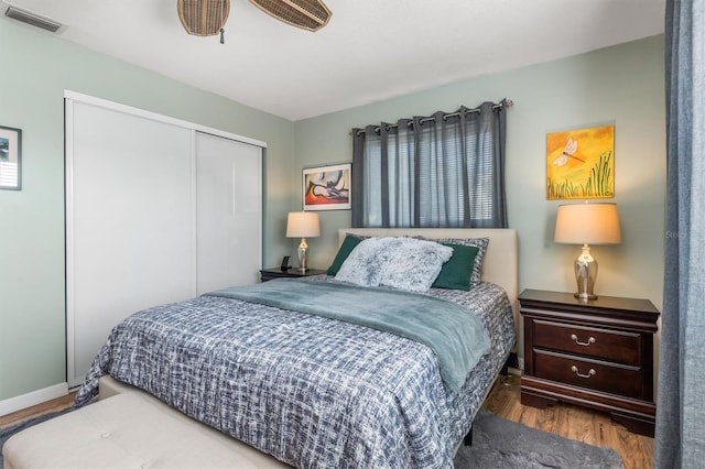 bedroom with a closet, ceiling fan, and wood-type flooring