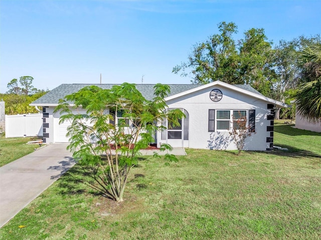 single story home featuring a front lawn and a garage