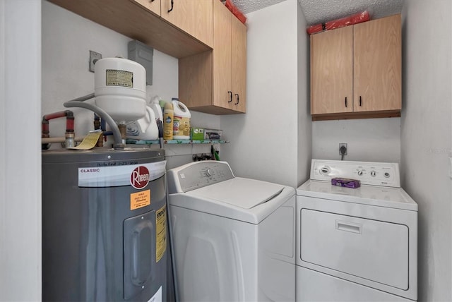 clothes washing area with electric water heater, cabinets, a textured ceiling, and independent washer and dryer