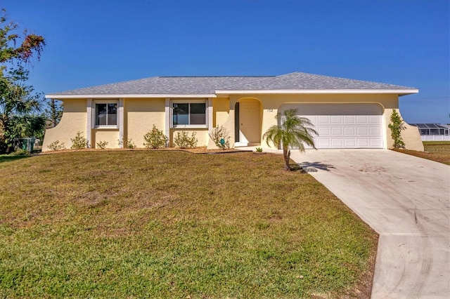 ranch-style house featuring a front yard and a garage