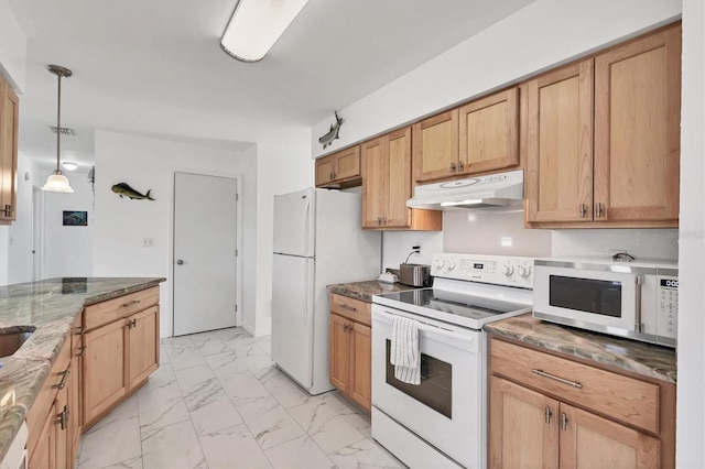 kitchen featuring white appliances, dark stone countertops, and hanging light fixtures