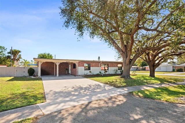 ranch-style house featuring a front lawn and a carport