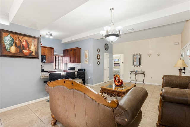 living room with light tile patterned floors and an inviting chandelier