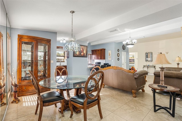 tiled dining area featuring an inviting chandelier