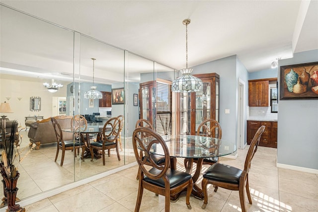 dining area featuring light tile patterned floors, an inviting chandelier, and a wealth of natural light