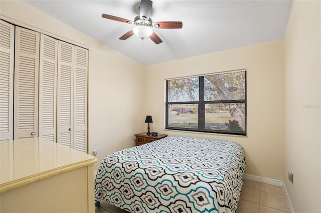 bedroom featuring vaulted ceiling, a closet, tile patterned floors, and ceiling fan