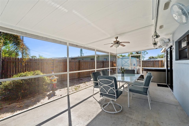 unfurnished sunroom with ceiling fan