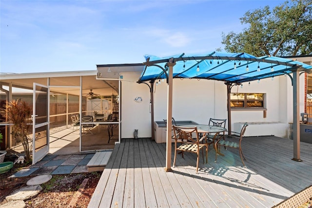 deck with a pergola and a sunroom