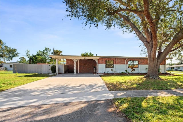 ranch-style home with a carport and a front lawn