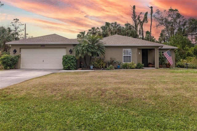 ranch-style house with a lawn and a garage