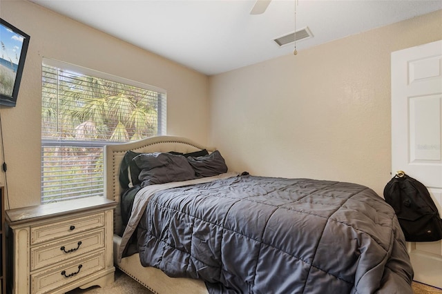 bedroom with ceiling fan and light carpet