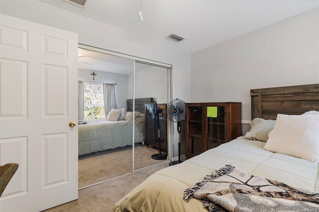 bedroom with a closet and light carpet